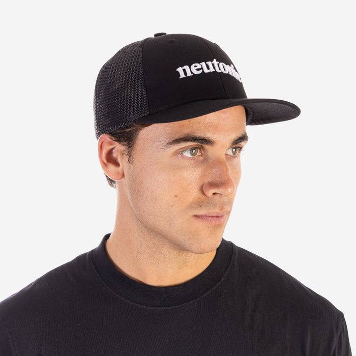 Black trucker cap with white "neutro" embroidery, mesh back, and curved brim, worn with black shirt. - Neutonic - Trucker Cap