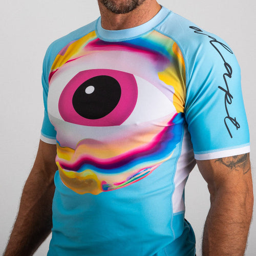 Men's rash vest in turquoise with large colorful eye graphic and black nootropics signature on sleeve. - Neutonic - Neutonic Rash Vest - Men